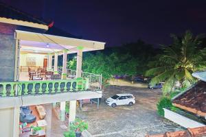 a house with a car parked in a parking lot at Penginapan Barokah in Kemadang