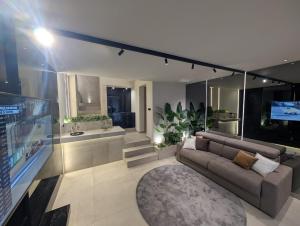 a living room with a couch and a television at Twentyseven Luxury Suite in Catania