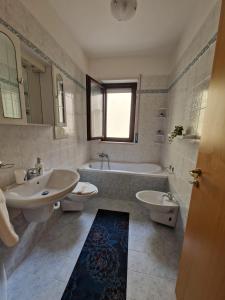 a bathroom with two sinks and a tub and two toilets at Cavalluccio Marino-Central-with Balcony by Gessica Holiday in Polignano a Mare +34 photos