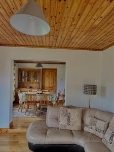 a living room with a couch and a dining room at Beautiful Beach Side Bungalow in Galway