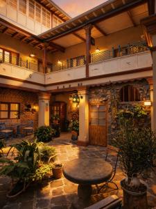 an indoor patio with a table in a building at Old Town Quito Suites, Heritage Hotel, Historic center in Quito