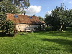 a house with a picnic table in a yard at Secluded 17th Century converted barn in Midhurst +7 photos