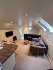 a living room with a couch and a table at Brylach Steading in Aberlour