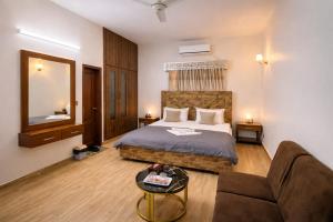a hotel room with a bed and a couch at Amada Family Guest House in Karachi