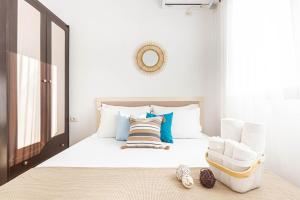 a bedroom with a bed with a chair and a mirror at Shiny 2 Central Stay in Himare