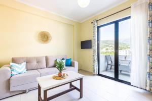 a living room with a couch and a table at Shiny 2 Central Stay in Himare