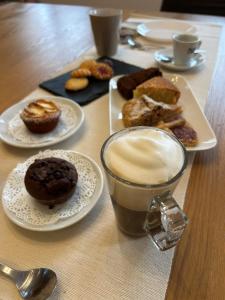 a table with plates of donuts and a cup of coffee at B&B Il Sentiero in Noale