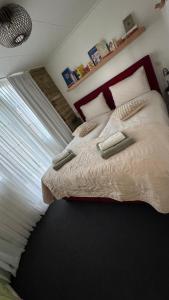 a bedroom with a large bed with a window at Janka B&B in Elim