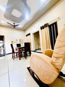 a living room with a couch and a table at Vrindas Home Stay in Maheshwar +63 photos
