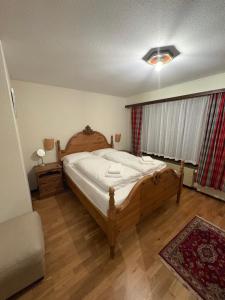 a bedroom with a large wooden bed in a room at Modern Täsch Apartment with Free Parking in Täsch