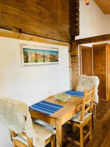 a dining room with a wooden table and chairs at Niesenblick in Aeschlen +25 photos