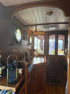 a kitchen with a sink and a counter top at Salonboot de Wending in Groningen +22 photos