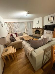 a living room with a couch and a fireplace at Modern Täsch Apartment with Free Parking in Täsch