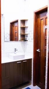a bathroom with a sink and a mirror at Valhali Guesthouse in Huraa +22 photos