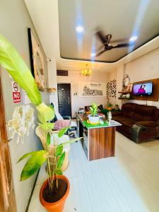 a living room with a couch and a table at Vrindas Home Stay in Maheshwar