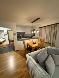 a living room and kitchen with a couch and a table at Modern Täsch Apartment with Free Parking in Täsch