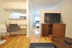 a living room with a flat screen tv on a wooden entertainment center at The Austin Cool Condo in Austin