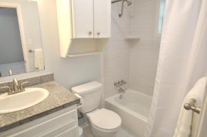 a white bathroom with a toilet and a sink at The Austin Cool Condo in Austin +19 photos