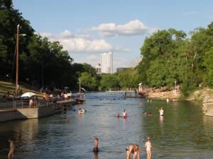 a group of people swimming in a river at The Austin Cool Condo in Austin