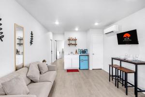 a living room with a couch and a kitchen at The Container Retreat - 6A.. in Canyon Lake