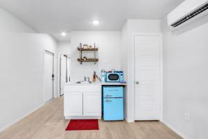 a kitchen with a blue refrigerator and a sink at The Container Retreat - 6A.. in Canyon Lake