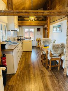 a kitchen and dining room with a table and chairs at Niesenblick in Aeschlen