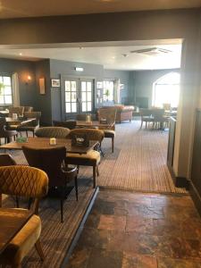a restaurant with tables and chairs in a room at Sandy Toes, The Bay, Filey in Filey