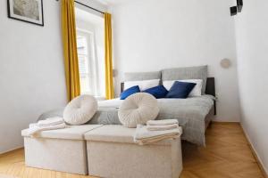 a bedroom with a bed with blue pillows and a mirror at Štúr Apartment Michalská in Bratislava
