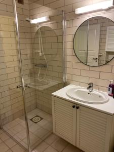a bathroom with a shower and a sink and a mirror at Charming view in Olden +29 photos