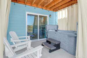 a blue house with two chairs and a grill on a porch at The Container Retreat - 7A.. in Canyon Lake