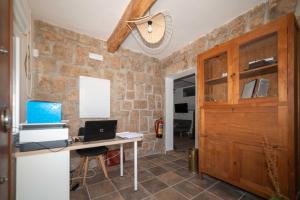 a room with a desk with a computer on it at Finca Avellaneda in Navahonda
