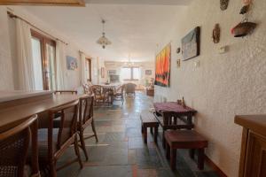 a restaurant with tables and chairs and a dining room at Dual bay views by ΜΡS in Dhaskalión