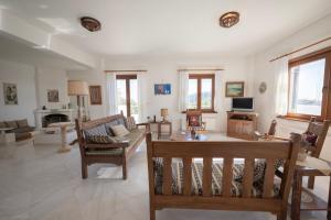 a living room with a couch and a table at Dual bay views by ΜΡS in Dhaskalión