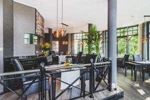 a dining room with black chairs and a table at Hotel BEI SCHUMANN in Kirschau