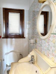 a bathroom with a sink and a toilet and a mirror at Dual bay views by ΜΡS in Dhaskalión +66 photos