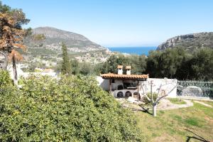 a house on a hill with the ocean in the background at Dual bay views by ΜΡS in Dhaskalión