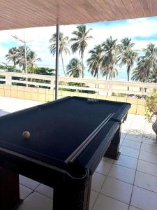 a pool table with a view of the beach at Litorânea Top View ' Beira Mar ' 15 Hospedes in São Luís