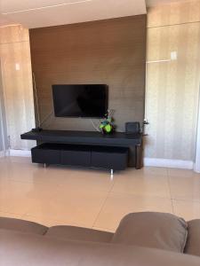a living room with a flat screen tv on a wall at Litorânea Top View ' Beira Mar ' 15 Hospedes in São Luís +21 photos