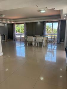 a large empty room with a table and chairs at Litorânea Top View ' Beira Mar ' 15 Hospedes in São Luís