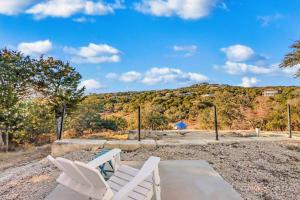 two white chairs sitting on a patio with a mountain at The Container Retreat - C10 in Canyon Lake