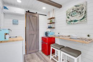 a small kitchen with a red refrigerator and a counter at The Container Retreat - C10 in Canyon Lake +7 photos