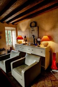 a living room with couches and a table with lamps at Cité Plantagenêt, Jardin & piscine 24H du Mans in Le Mans