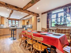 a kitchen with a table with a red table cloth at 4 Bed in Bridgnorth oc-oship in Highley