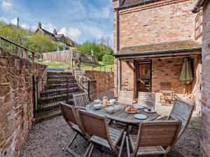 a wooden table and chairs in a yard at 4 Bed in Bridgnorth oc-oship in Highley