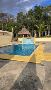 a swimming pool in a park with a gazebo at Hotel El Paraíso Calakmul - Jungle Experience in Xpujil +30 photos