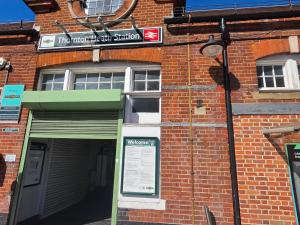 a brick building with a street sign on it at Zesty Zen in Thornton Heath +1 photo