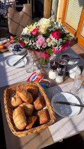 a table with a basket of bread and a bouquet of flowers at Ostseeperle Zingst, strandnahes 3-Zimmer Apartment in Zingst