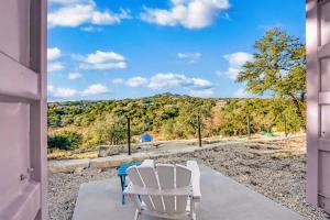 a pair of white chairs sitting on a porch at The Container Retreat - C11.. in Canyon Lake