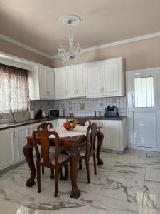 a kitchen with a table and chairs and a chandelier at Anastasia's House Kos in Marmaroto +12 photos