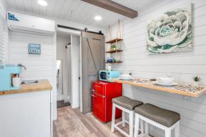 a kitchen with a red refrigerator and a counter at The Container Retreat - C12.. in Canyon Lake +5 photos
